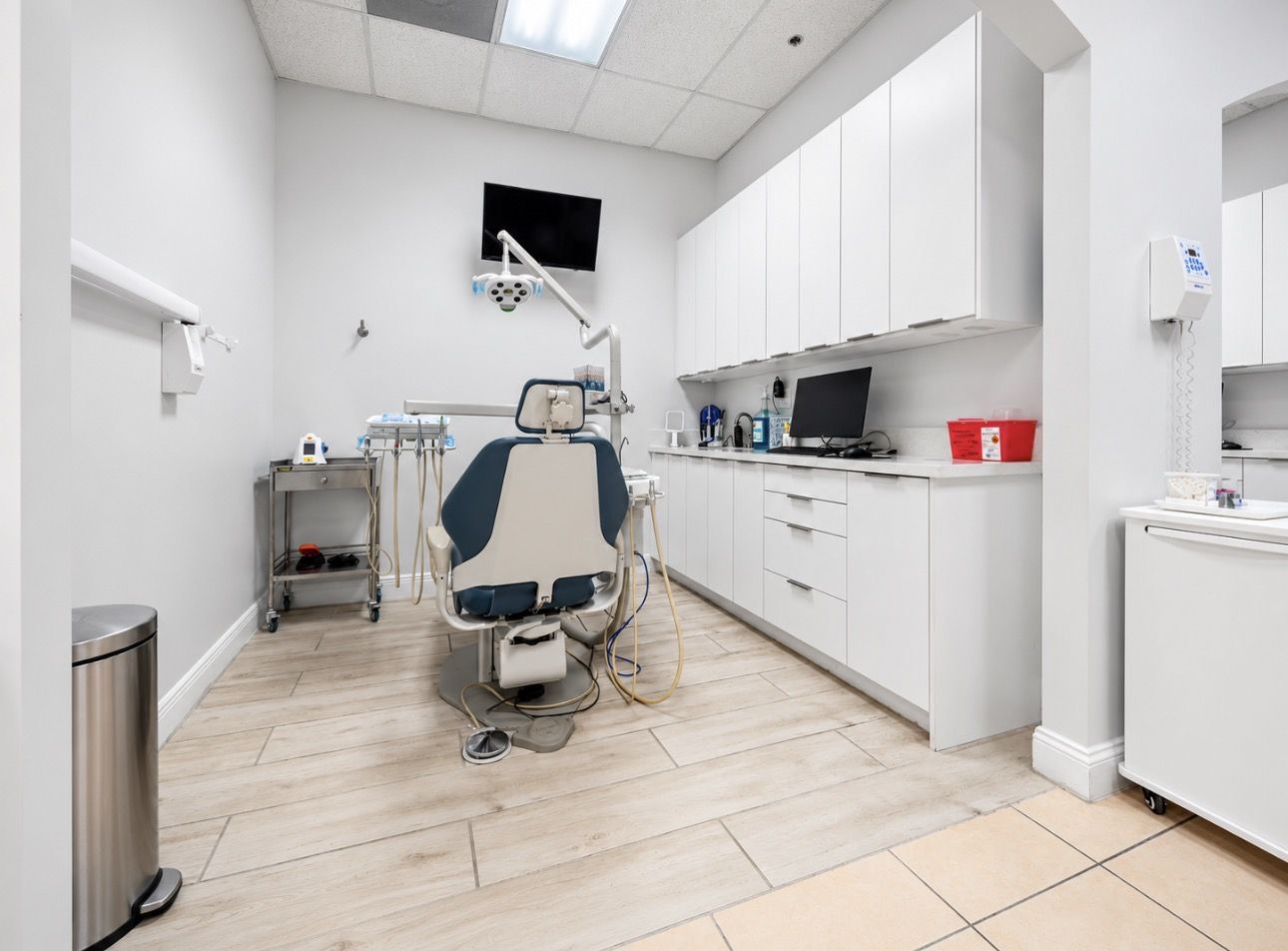 A second treatment room with a dental chair and monitor